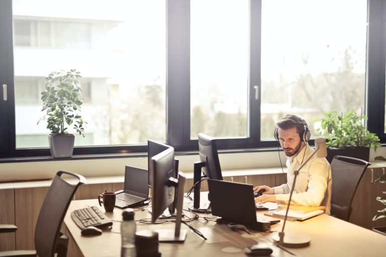 A virtual bookkeeper working at his desk. Photo credit: Andrea Piacquadio via Pexels.