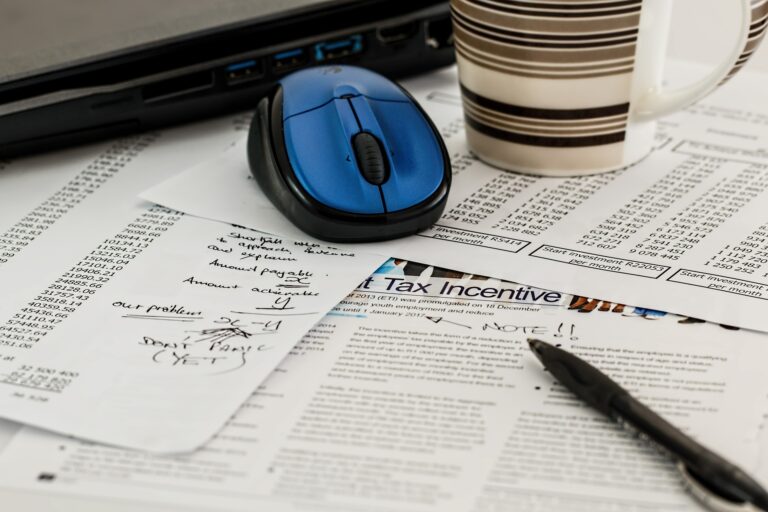 Bookkeeping paperwork sprawled out across a desk.