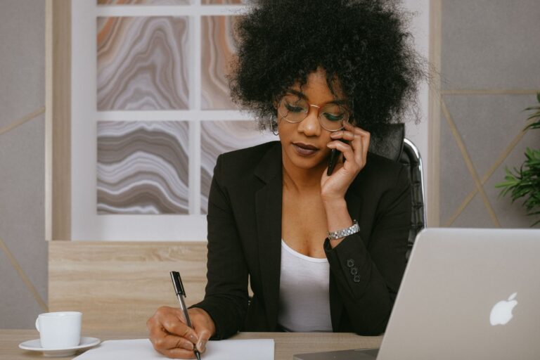 A businesswoman on the phone inquiring about professional bookkeeping services.