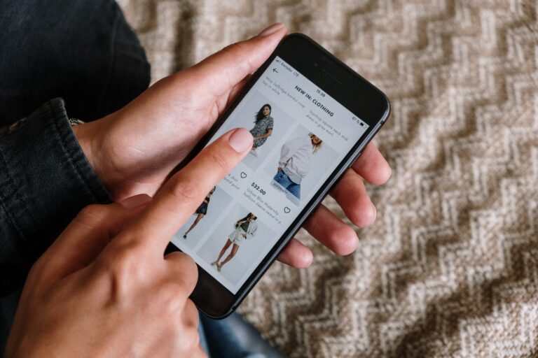 A person shopping for clothes online using their mobile device.